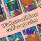 Holographic coffee packages with colorful labels on a pink background